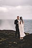 Bride and groom on sea cliffs in hawaii